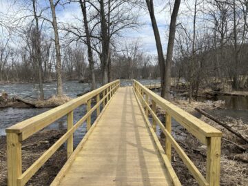 A picture of newly built wooden walkway with rails