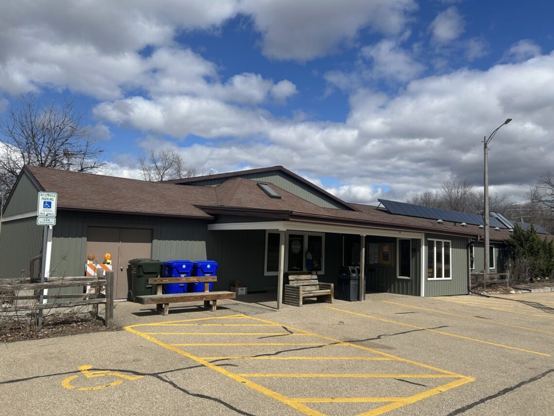 Picture of the Nature center, a green-sided building with brown roof