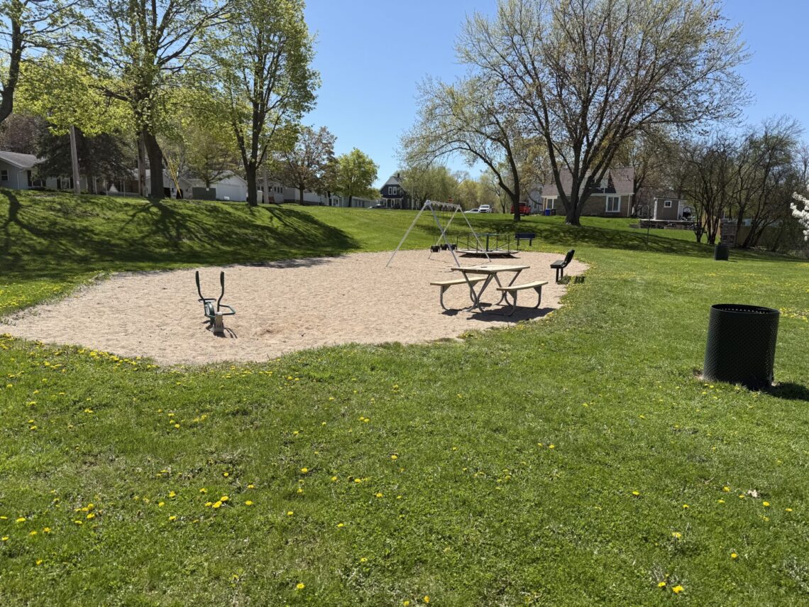 Picture of a swing set, picnic table and a bench