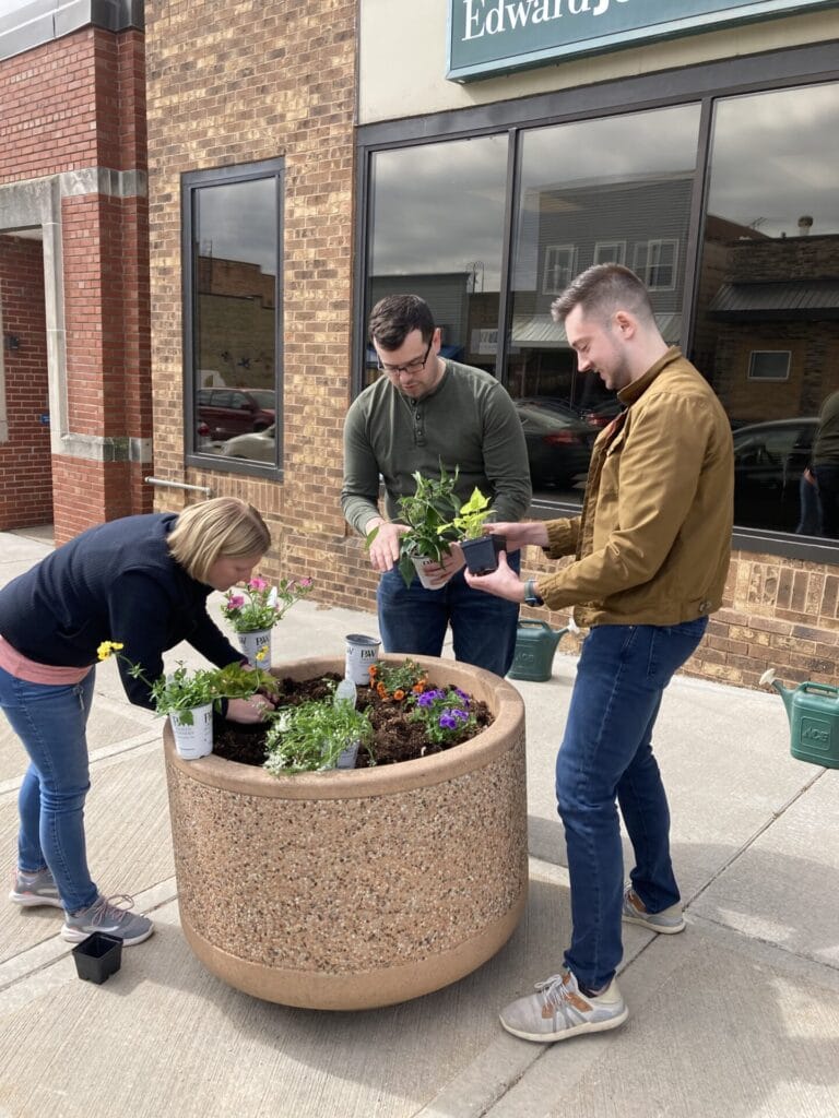 Finance Department staff and the City Attorney plant flowers downtown as part of annual beautification project.