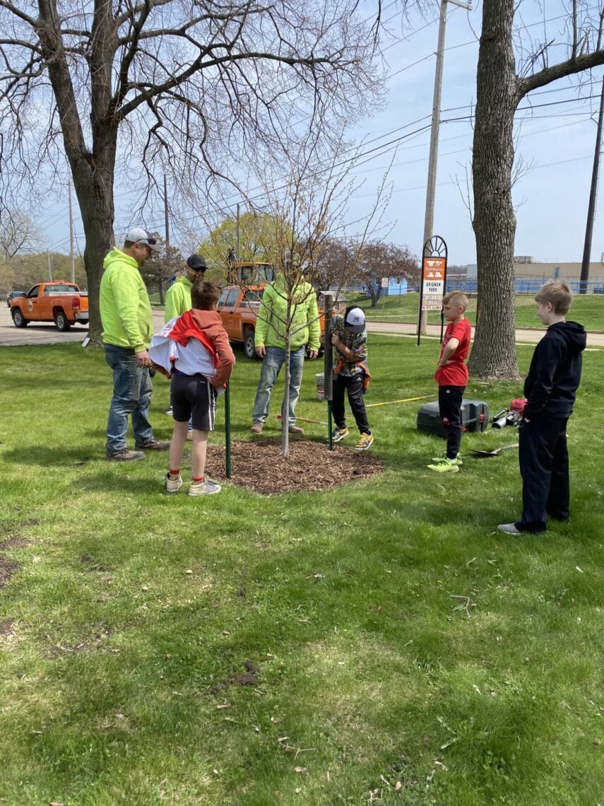 City Staff and fifth grade students f rom the Riverview Middle School plant trees in Grignon Park. 4/2025
