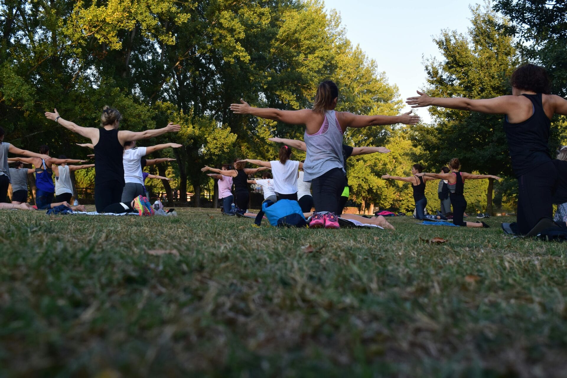 Stock image of people doing yoga outside by Rui Dias