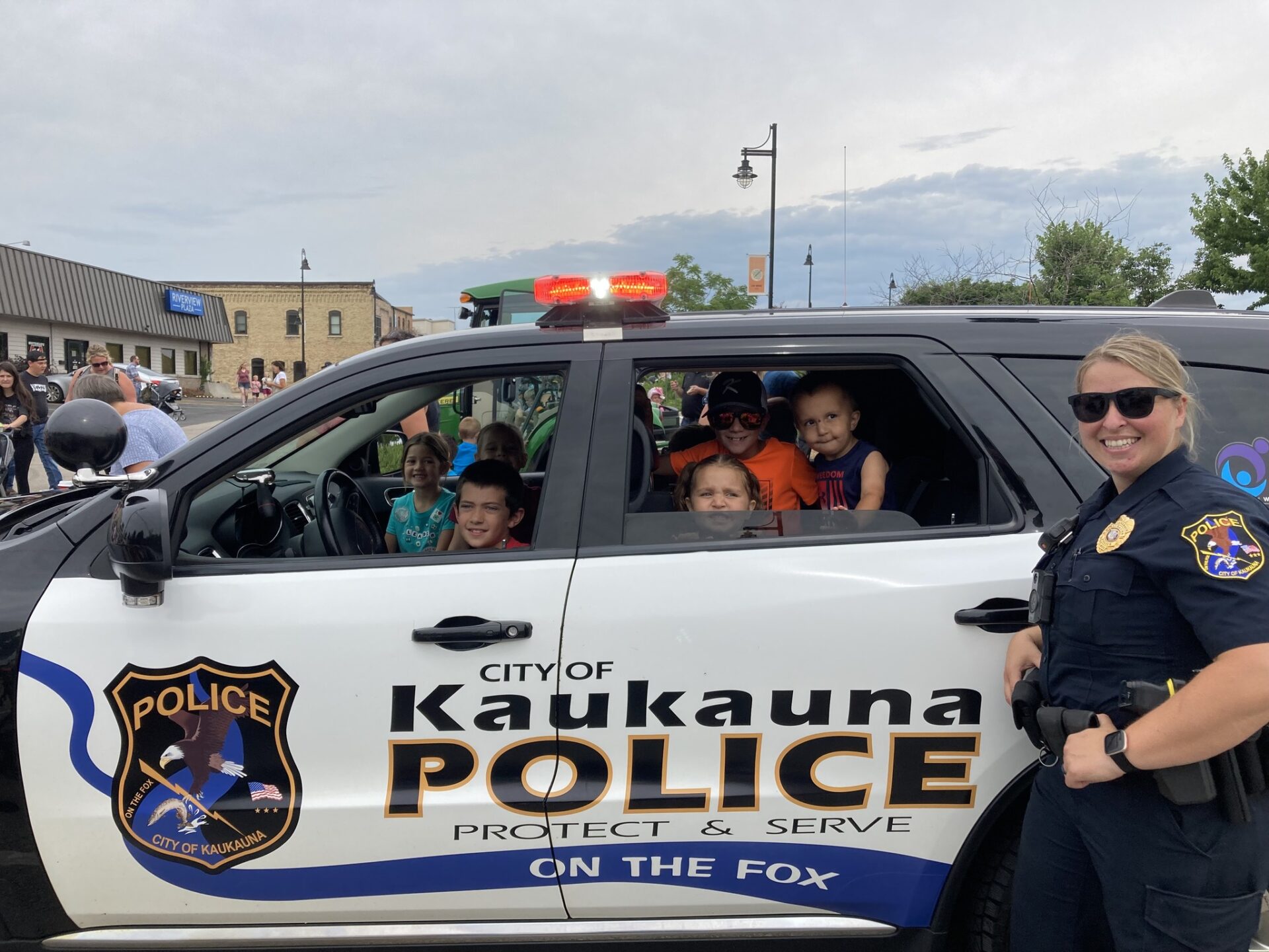 Children getting to see a police car up close.
